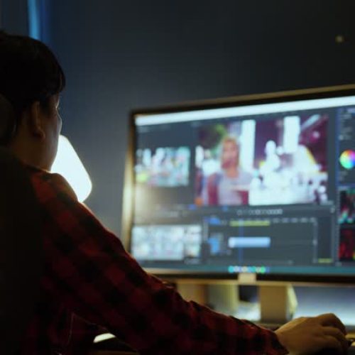 Male Videographer Edits and Cuts Footage